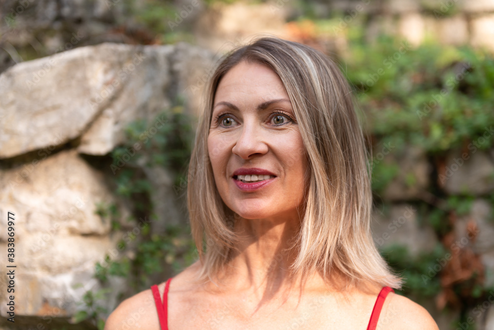 Close up happy adult woman with long blond hair