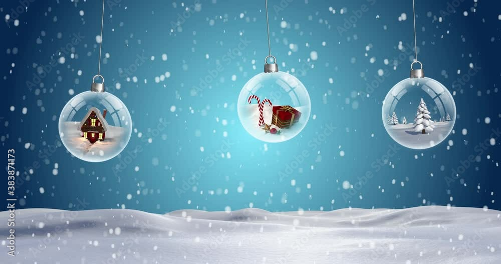 Three clear Christmas baubles dangling against snowflakes falling on snow landscape