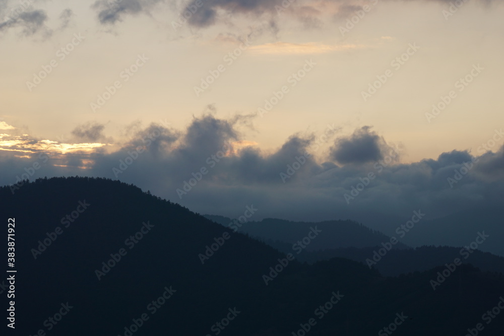 Captivating mountain landscape with cumulus clouds and sunset in the Rhodope Mountains, Bulgaria