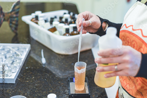 Measuring out essential oils for ingriedients to make home made scented candles photo