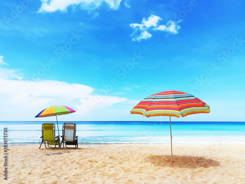 Umbrellas and chair on beach in vacation. © D.APIWAT