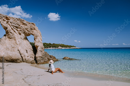 Tropical beach of Voulisma beach, Istron, Crete, Greece ,Most beautiful beaches of Crete island -Istron bay near Agios Nikolaos young asian woman mid age on vacation Greece Crete photo