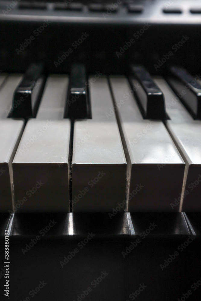 keys of a piano in dark shadow and bright light