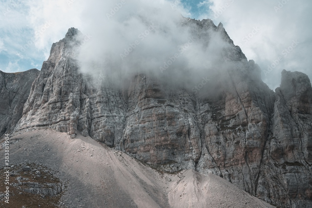 A rocky peak of a mountain surrounded by clouds in the Sibillini National Park (Marche, Italy, Europe)