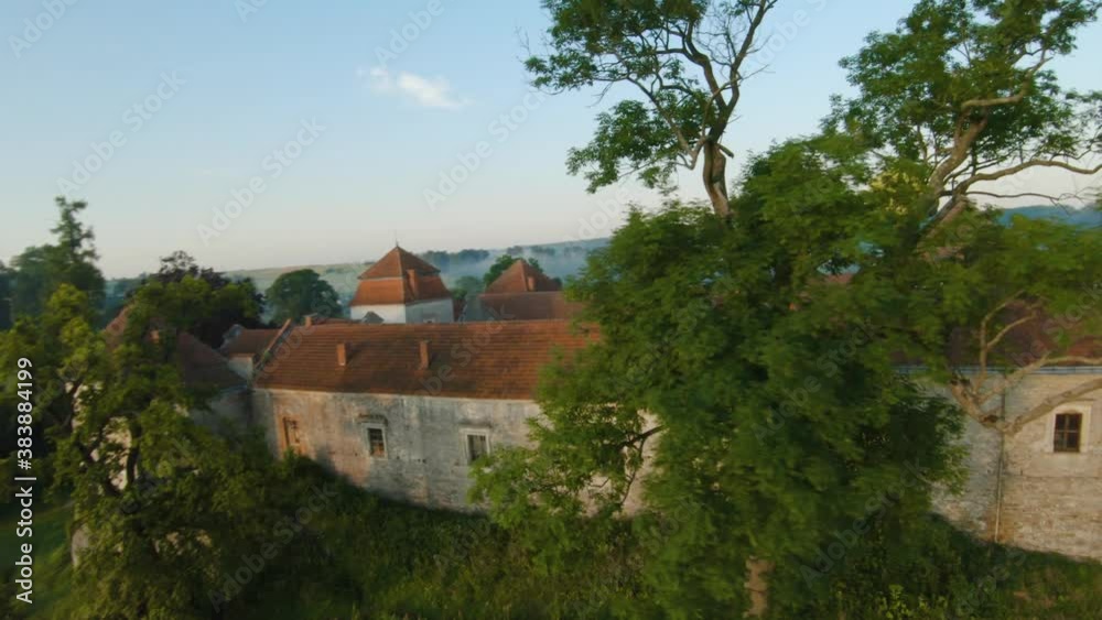 Colorful hot air balloons fly over the medieval castle and lake in the morning fog. Maneuverable flight. Travel, adventure, festival. Colorful hot air balloons fly over the medieval castle and lake in the morning fog. Maneuverable flight. Travel, adventure, festival.