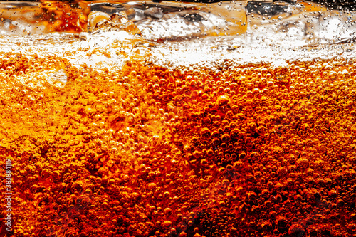 Close up view of the ice cubes in cola background ,Detail of Cold Bubbly Carbonated Soft Drink with Ice 