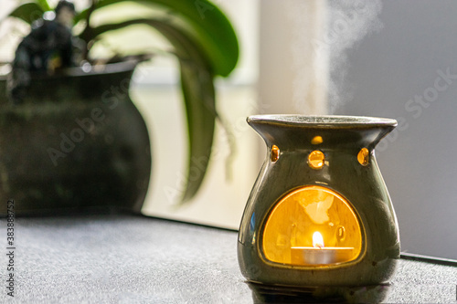 Quadro su tela essential oil burner near orchid on table
