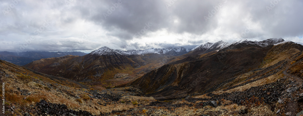 Panoramic View of Scenic Landscape, Valley and Mountains in Canadian Nature. Season change from Fall to Winter. Taken in Tombstone Territorial Park, Yukon, Canada.