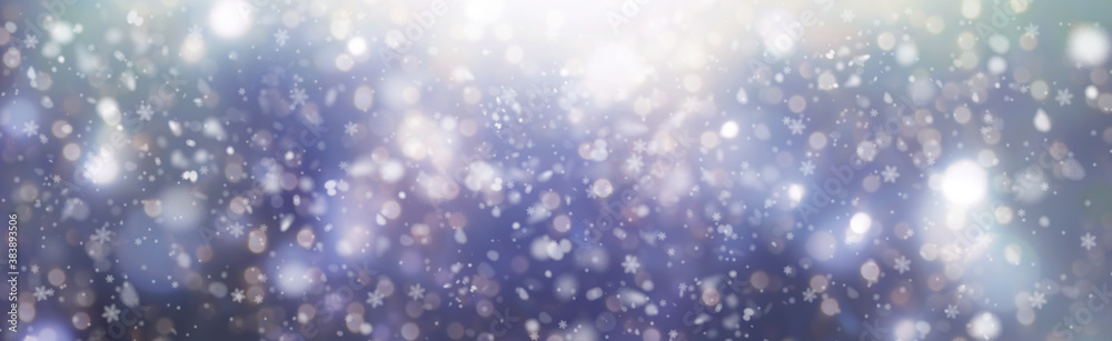 White snowflakes on a blue bokeh  background fall from the sky - Christmas and winter background panorama
