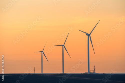 Windmills for electric power production at sunset