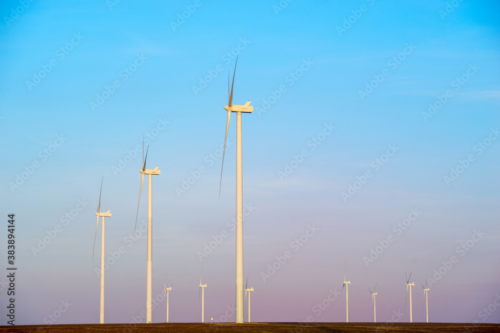 Fototapeta premium Windmills for electric power production at sunset