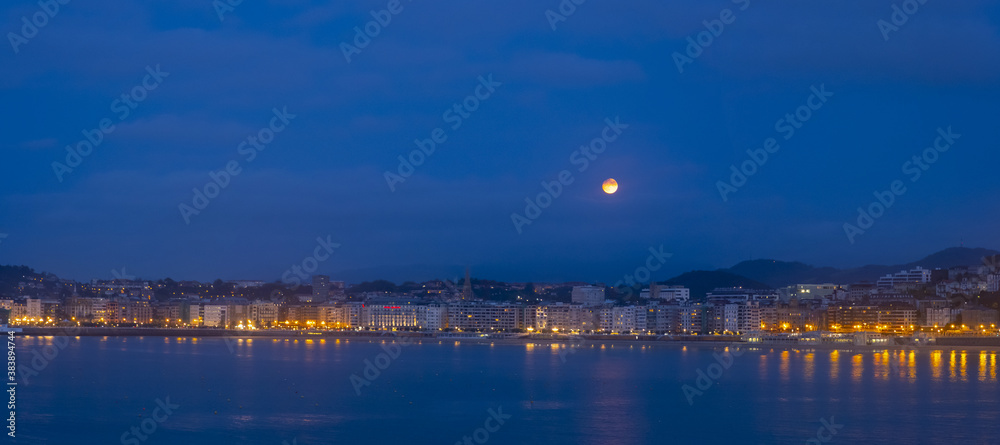 La Concha bay with full moon, city of Donostia, Euskadi