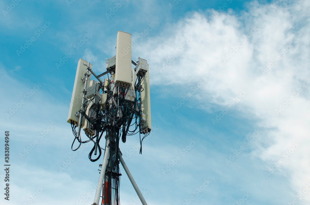 Telecommunication tower for 5G network, on blue sky background, technology photo conceptual.