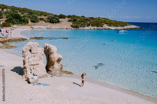 Fototapeta Naklejka Na Ścianę i Meble -  Tropical beach of Voulisma beach, Istron, Crete, Greece, couple on vacation in Greece