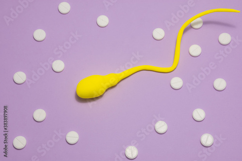3D anatomical model of sperm cell or spermatozoon is on purple background surrounded by white pills ornament polka dots. Photo concept of treatment of sperm diseases, cell pathology, male infertility