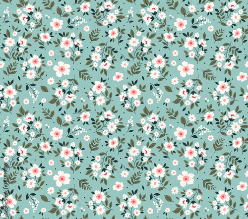 Trendy seamless vector floral pattern. Endless print made of small white flowers. Summer and spring motifs. Light blue background. Vector illustration.