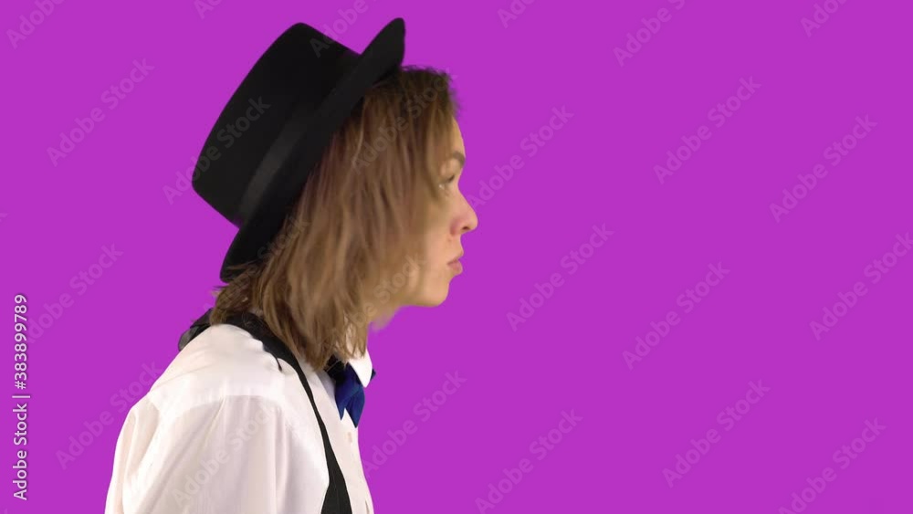 Profile of a Woman in a hat shaking her fist angrily on a purple background. Swearing woman in a suit. Profile of a Woman in a hat shaking her fist angrily on a purple background. Swearing woman in a suit.
