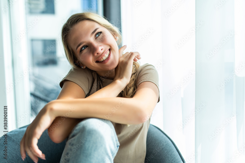 Young woman resting in chair at home Young woman resting in chair at home