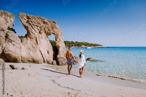Tropical beach of Voulisma beach, Istron, Crete, Greece ,Most beautiful beaches of Crete island -Istron bay near Agios Nikolaos young couple mid age on vacation in Greece Crete photo
