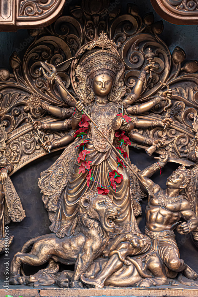 Idol of Goddess Devi Durga at a decorated puja pandal in Kolkata, West Bengal, India. Durga Puja is a famous and major religious festival of Hinduism that is celebrated throughout the world. Idol of Goddess Devi Durga at a decorated puja pandal in Kolkata, West Bengal, India. Durga Puja is a famous and major religious festival of Hinduism that is celebrated throughout the world.
