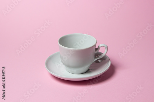 Coffee cup on a pink background. Coffee cup and saucer.