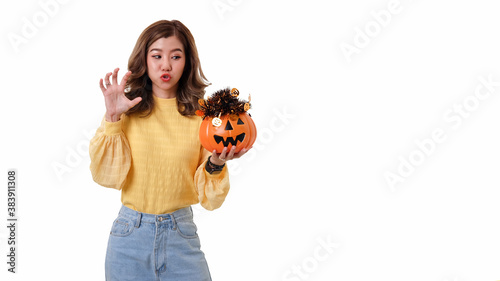Portrait of Asian woman holding curved pumpkin and looking at pumpkin isolated over white background Halloween concept.