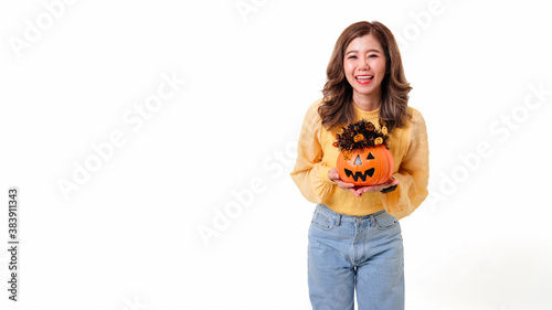 Portrait of Asian smiling woman holding curved pumpkin and looking at camera isolated over white background Halloween concept.