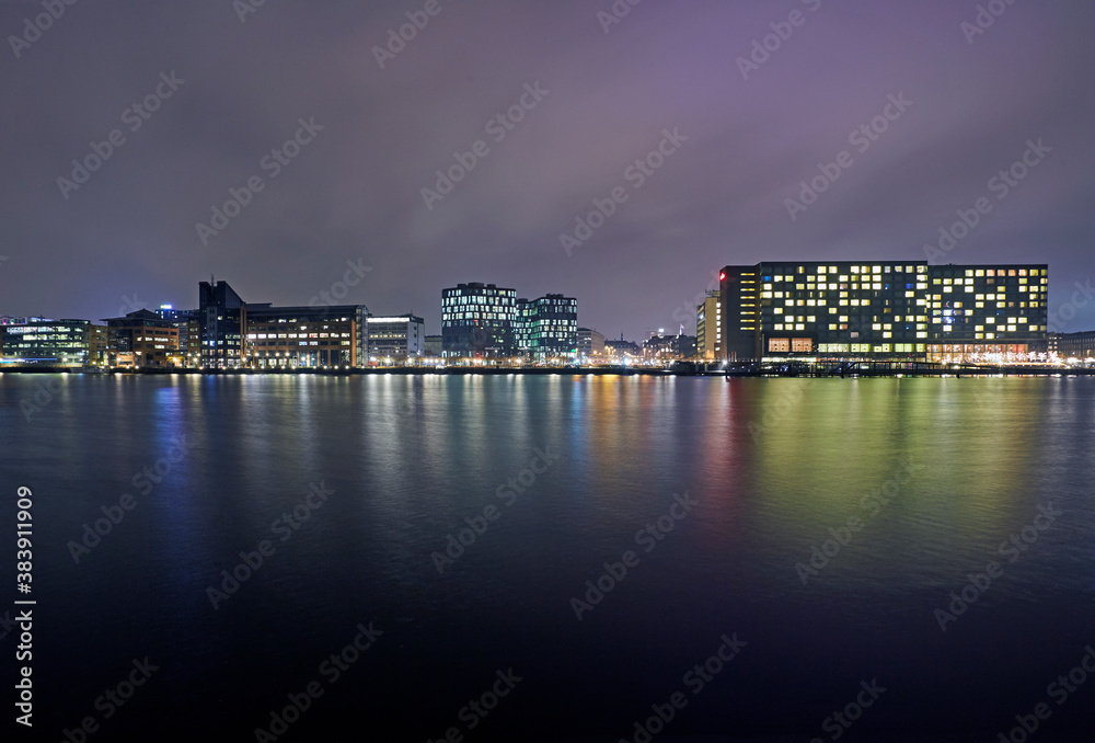 Modern architecture along the Kalvebod Brygge waterfront illuminated at night