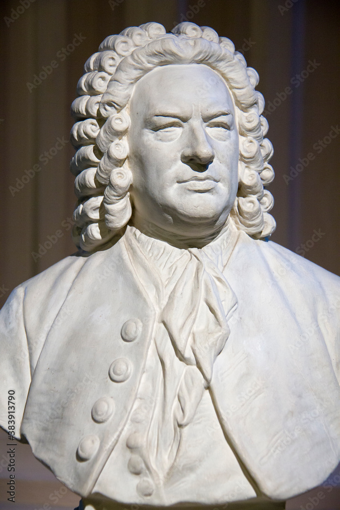 Vertical view of white bust of Johann Sebastian Bach (1685-1750), German baroque composer and musician, considered one of the greatest composers of all time - obrazy, fototapety, plakaty 