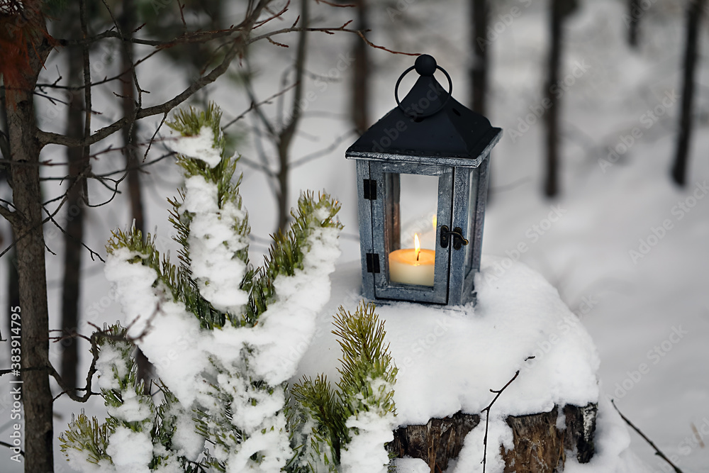 Lantern with a candle hanging on a tree in the winter forest. Lantern with a candle hanging on a tree in the winter forest.