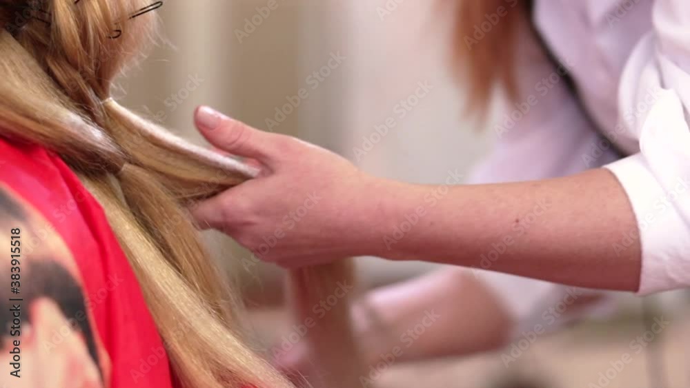 Hair stylist doing wedding hairstyle for long hair. Video