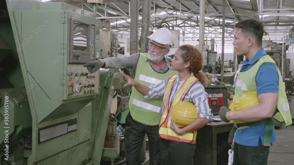 Group of engineer talking and training working using machine control together in industrial factory, foreman discussing and teaching trainee, people diversity, indoors, industry concept.
