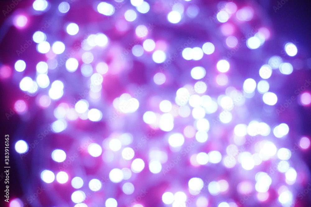 Blue lights on a purple background are blurred. Concept of blank frame,copy space. Christmas or new year flatlay background.