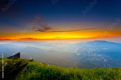 Canvas Print Sunset mountains with moody clouds