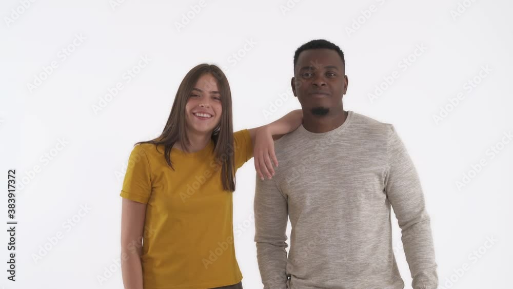 Friendly interracial couple giving fist bump. Greeting and approving gesture. Isolated on white background. Friendly interracial couple giving fist bump. Greeting and approving gesture. Isolated on white background.