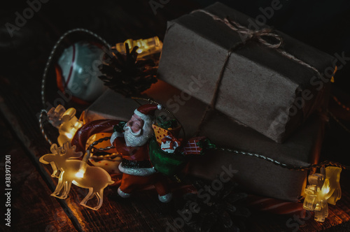 christmas gift wrapped in craft paper on wooden table, christmas gifts concept