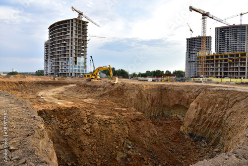 Digging the pit foundation a hole with excavator. Earthwork in excavation and backfilling of soil upto required depth is required for construction of trenche. Construction machinery for earthmoving