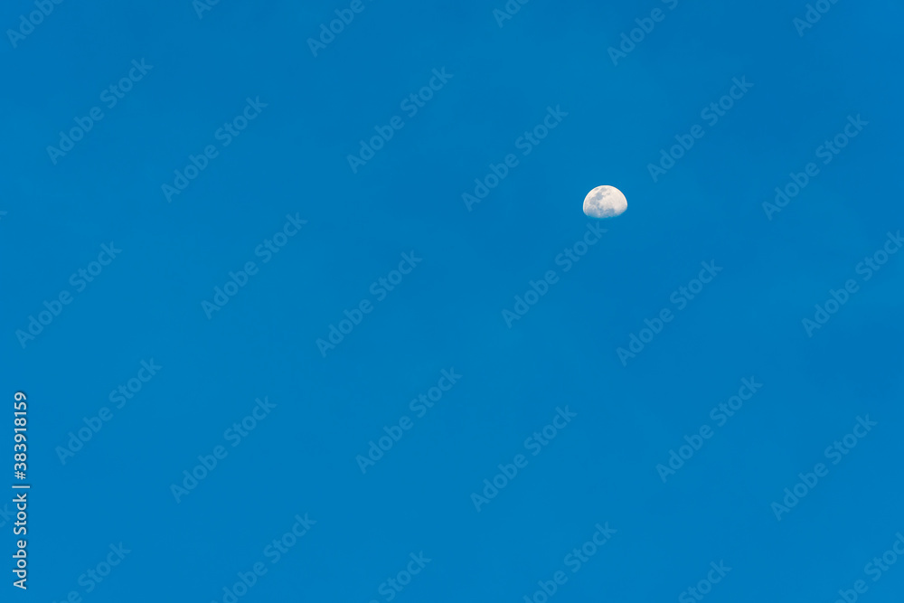 Beautiful texture of half moon with clear blue sky for background or wallpaper. Twilight scene. Beautiful texture of half moon with clear blue sky for background or wallpaper. Twilight scene.