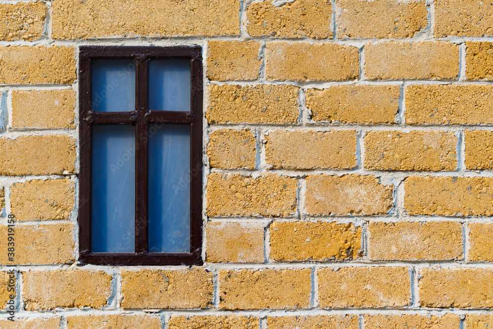 Fototapeta premium background from a miniature houses in a city park, yellow brick wall and windows