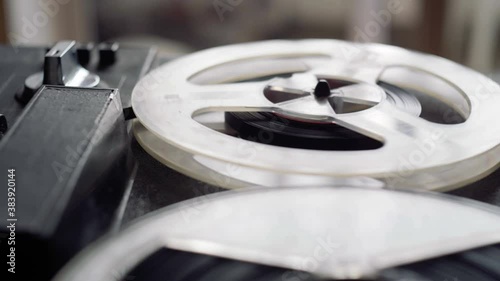 Reel film tape is rotating at a vintage professional player. Oldschool equipment