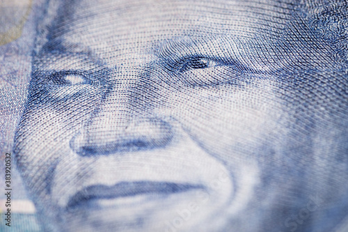 Horizontal marco detail of the image of Nelson Mandela in the obverse of South African ZAR banknote with a denomination of 100 rand