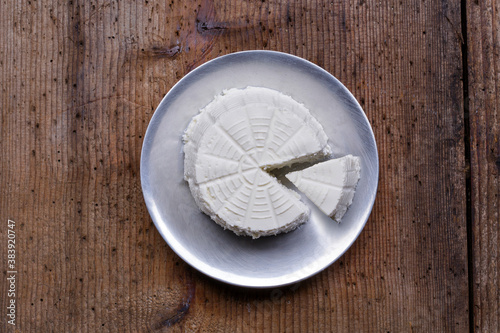 Ricotta cheese on wood background