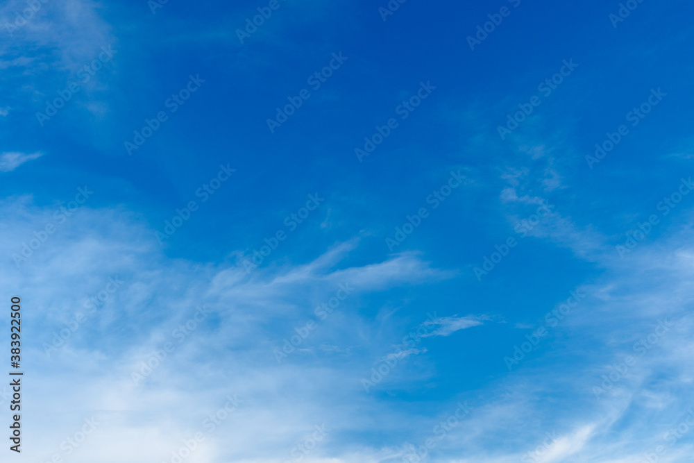 Cirrus and cumulus clouds on blue sky background..