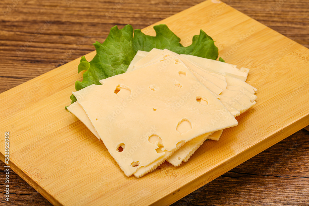 Sliced yellow cheese over board