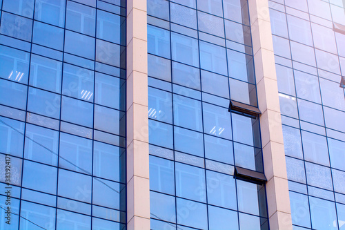 A glass facade of business center building background.