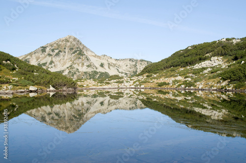 Fototapeta Naklejka Na Ścianę i Meble -  Muratov peak and its reflection in Banderishko Frog lake in the Pirin National Park, Bulgaria
