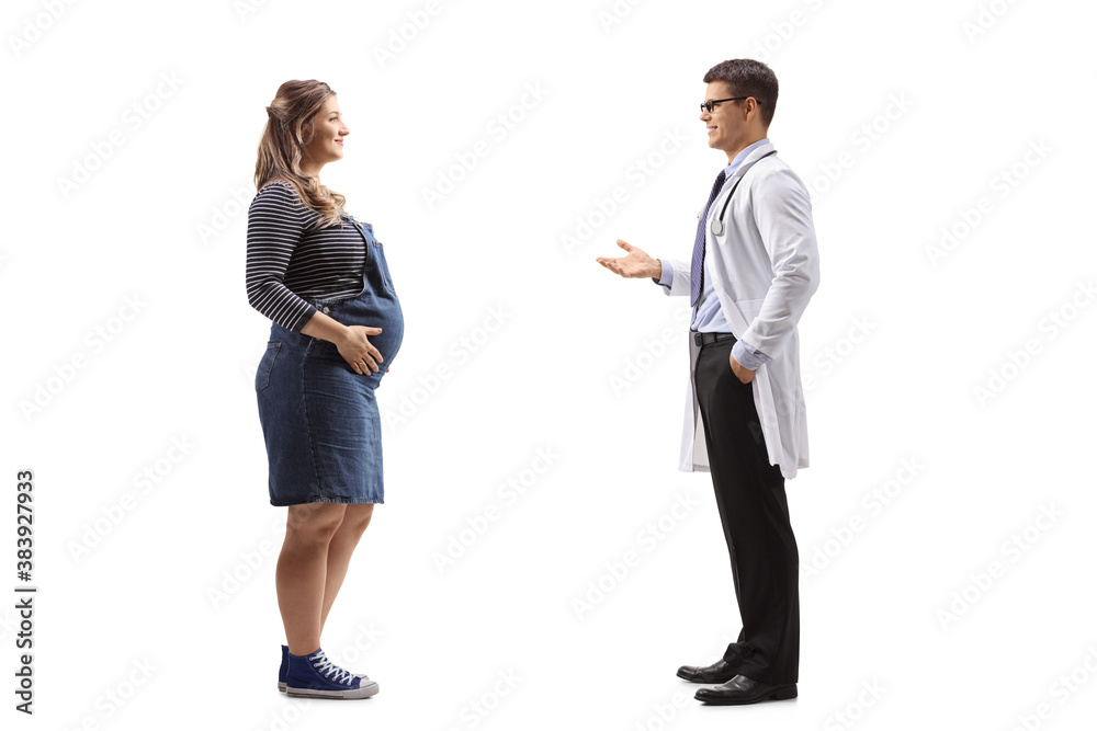 Full length profile shot of a pregnant woman talking to a male gynecologist
