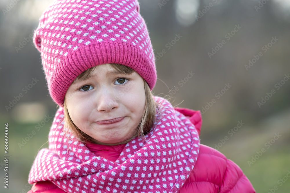 Pretty child girl in warm knitted winter clothes outdoors. Pretty child girl in warm knitted winter clothes outdoors.