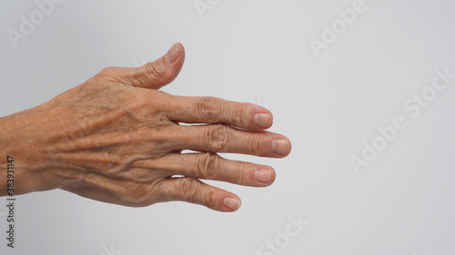 Back hand with wrinkle skin of senior or older woman on white background.