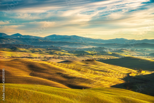 Volterra winter panorama, rolling hills and green fields on sunset. Tuscany, Italy